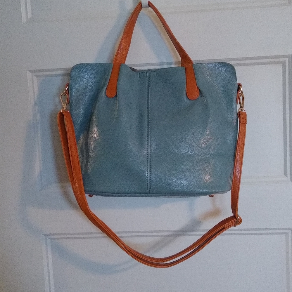 Light blue leather purse with tan trim.